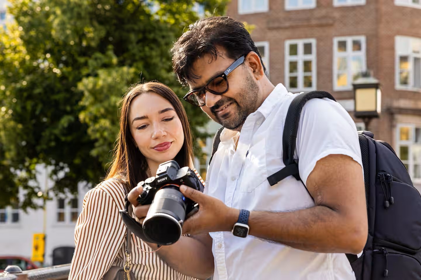 Savvy, portrait and wedding photographer in Copenhagen, reviewing photos on his camera