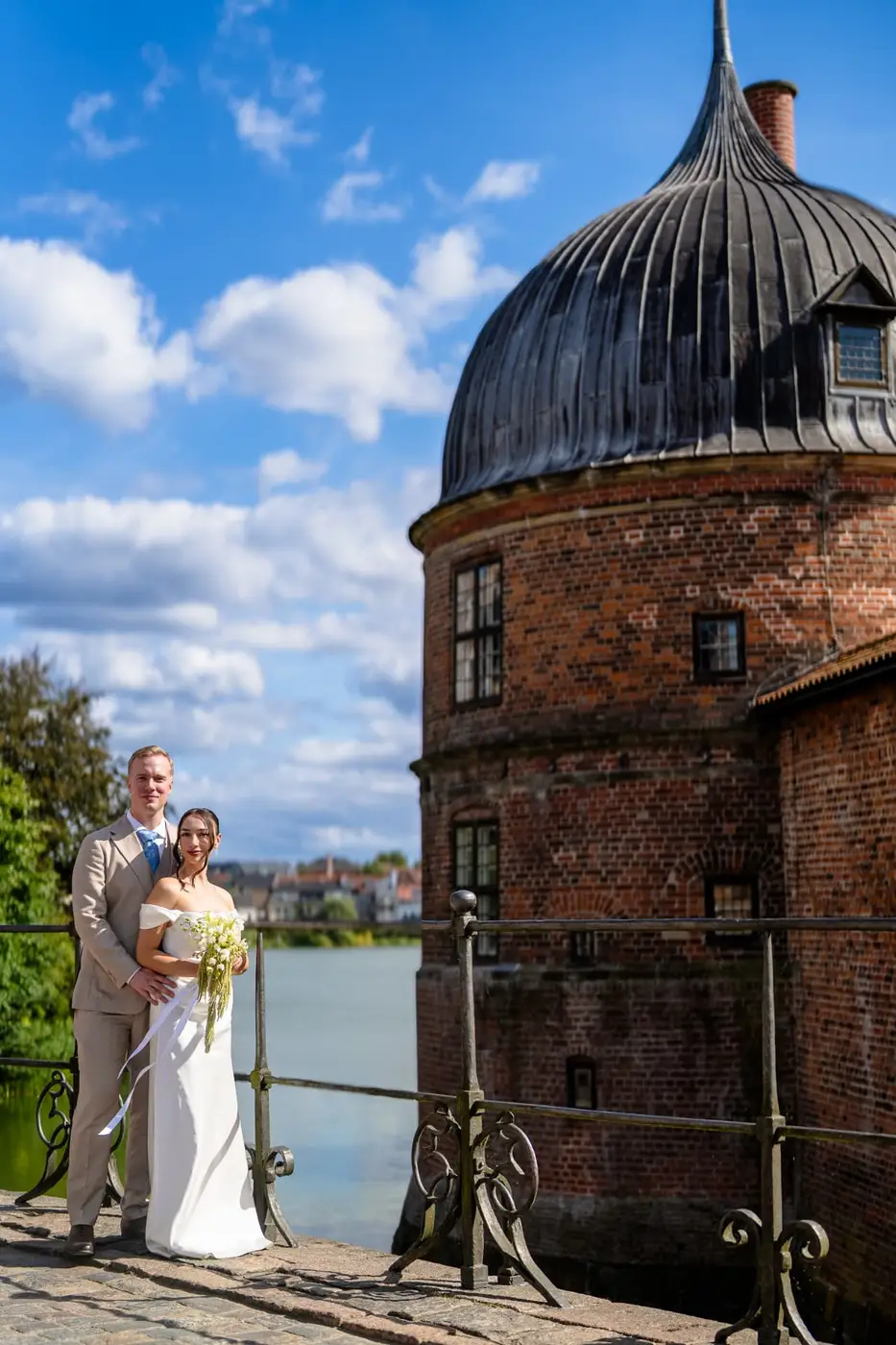 Bride and groom by the moat tower at Frederiksborg Slot, castle wedding photographer Hillerod Denmark